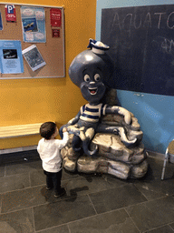 Max with an octopus statue in the lobby of the Aquatopia aquarium