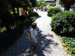 Max with a dinosaur toy at the entrance to the Den Botaniek botanical garden at the Leopoldstraat street