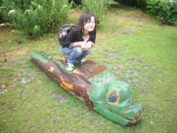 Miaomiao on a wooden crocodile in the Natuurpark Berg & Bos park