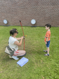 Miaomiao and Max shooting an arrow at the northeast side of the Palace Garden of Het Loo Palace, during the Princes and Princesses Day