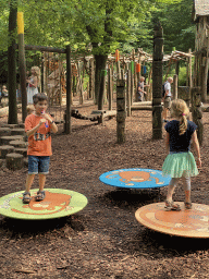 Max on a balancing plate at the Huis van NAAAP playground at the Apenheul zoo