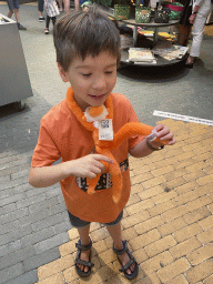 Max with a plush Monkey at the souvenir shop at the Apenheul zoo