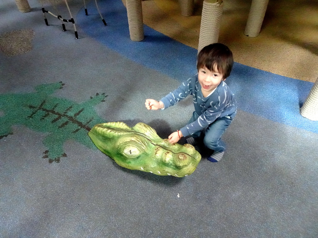 Max with a crocodile statue at the Kids Jungle playground at the Park Area of Burgers` Zoo