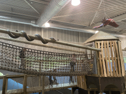 Walking bridge, snake statue and parrot statue at the Kids Jungle playground at the Park Area of Burgers` Zoo