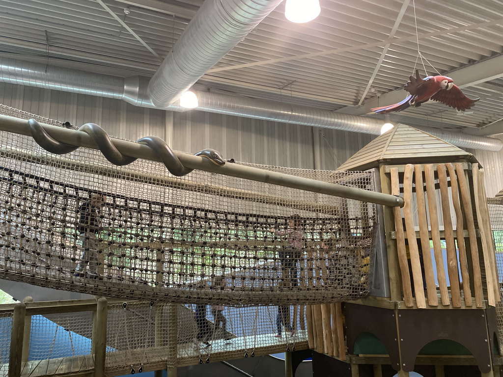 Walking bridge, snake statue and parrot statue at the Kids Jungle playground at the Park Area of Burgers` Zoo