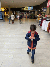 Max with Pokémon cards in front of the ToyChamp Arnhem store at the Lely shopping mall