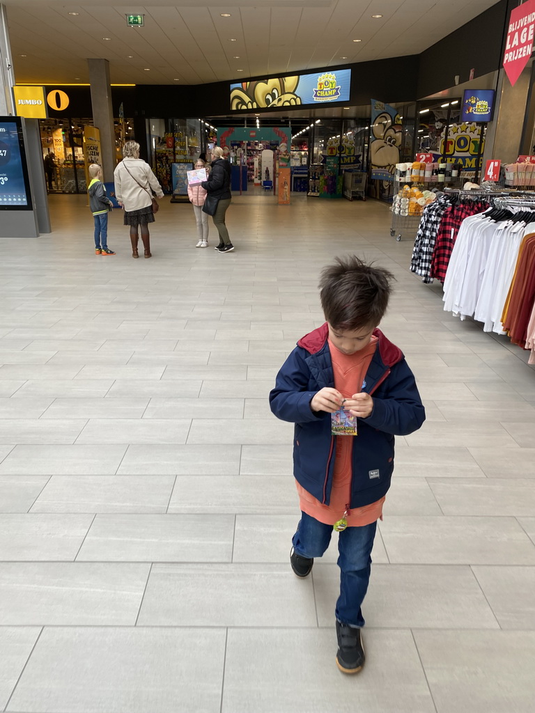 Max with Pokémon cards in front of the ToyChamp Arnhem store at the Lely shopping mall