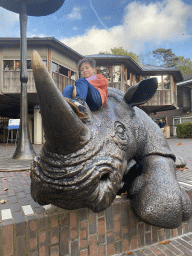 Max on the Rhinoceros statue at the entrance to Burgers` Zoo at the Antoon van Hooffplein square