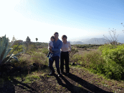 Tim, Miaomiao and Max on a parking place next to the Calle Camino-Real street, with a view on mountains and hills on the south side of the island