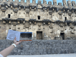 Stage building of the Roman Theatre of Aspendos, viewed from the orchestra, with a reconstruction in a travel guide