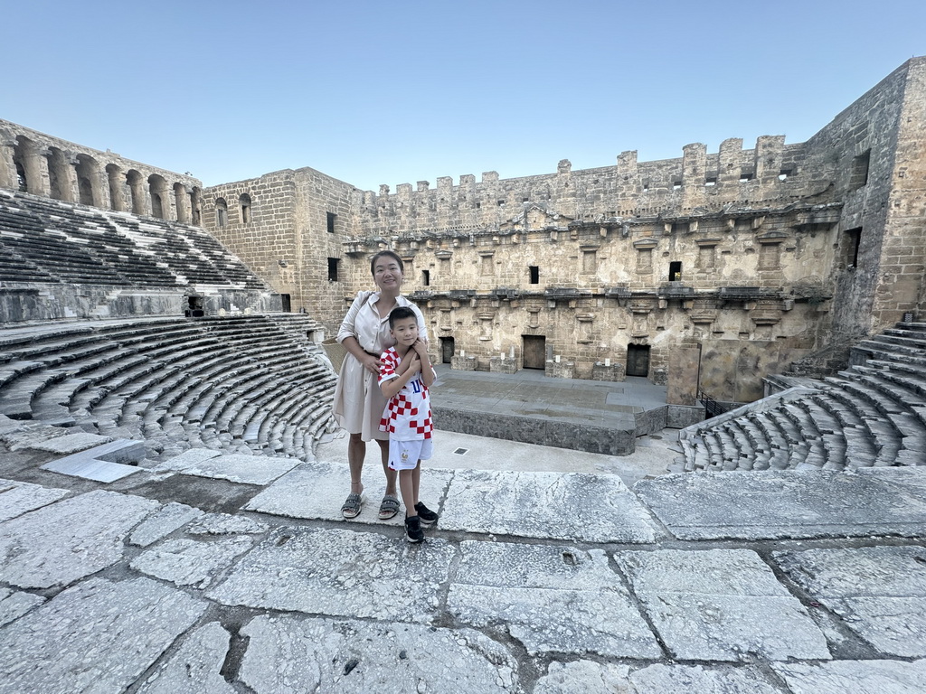 Miaomiao and Max at the diazoma of the west auditorium of the Roman Theatre of Aspendos, with a view on the orchestra, stage and stage building