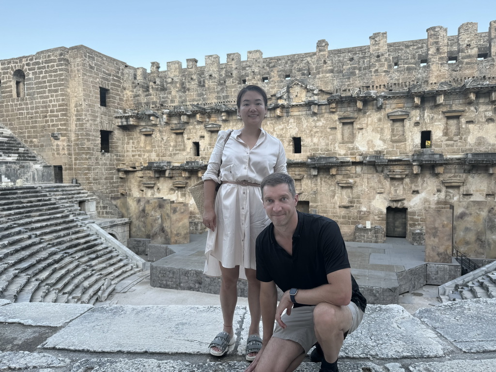 Tim and Miaomiao at the diazoma of the west auditorium of the Roman Theatre of Aspendos, with a view on the orchestra, stage and stage building