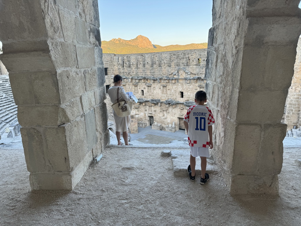 Miaomiao and Max at the top of the southwest auditorium of the Roman Theatre of Aspendos, with a view on the stage and stage building