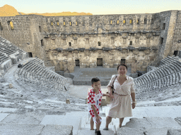Miaomiao and Max at the top of the west auditorium of the Roman Theatre of Aspendos, with a view on the auditorium, orchestra, stage and stage building