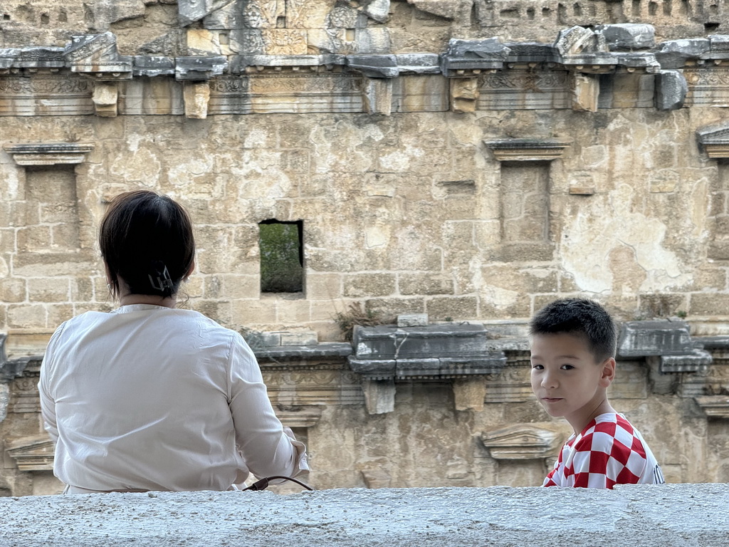 Miaomiao and Max at the top of the west auditorium of the Roman Theatre of Aspendos, with a view on the stage building