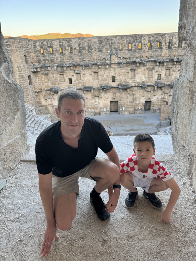 Tim and Max at the top of the west auditorium of the Roman Theatre of Aspendos, with a view on the stage and stage building