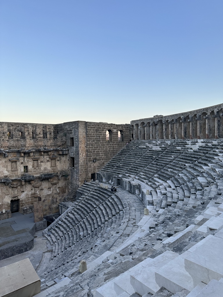 Tim and Max climbing down the south auditorium of the Roman Theatre of Aspendos, viewed from the top of the west auditorium