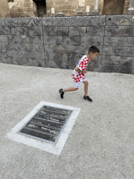 Max pretending to fight at the orchestra of the Roman Theatre of Aspendos