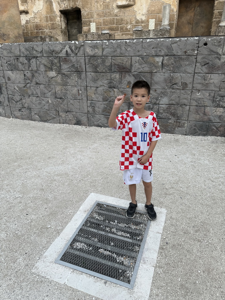 Max throwing a coin at the orchestra of the Roman Theatre of Aspendos