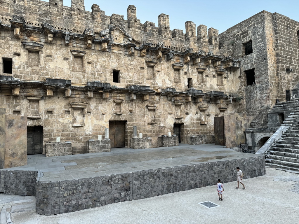 Miaomiao and Max with the orchestra, stage and stage building of the Roman Theatre of Aspendos, viewed from the northwest auditorium