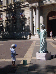 Living statue in front of the City Hall at the Place de l`Horloge square