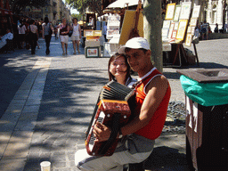 Miaomiao with street musician at the Place de l`Horloge square