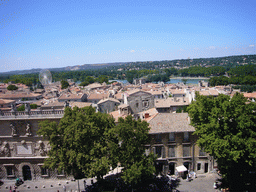 The south side of the Place du Palais square, the Rhône river and a ferris wheel, viewed from the roof of the Palais des Papes palace