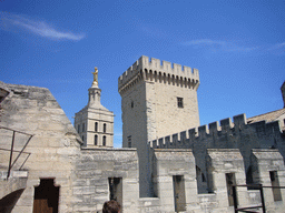 The Tour de la Campane tower of the Palais des Papes palace and the Gilded statue of the Virgin Mary at the top of the Avignon Cathedral, viewed from the roof of the Palais des Papes palace