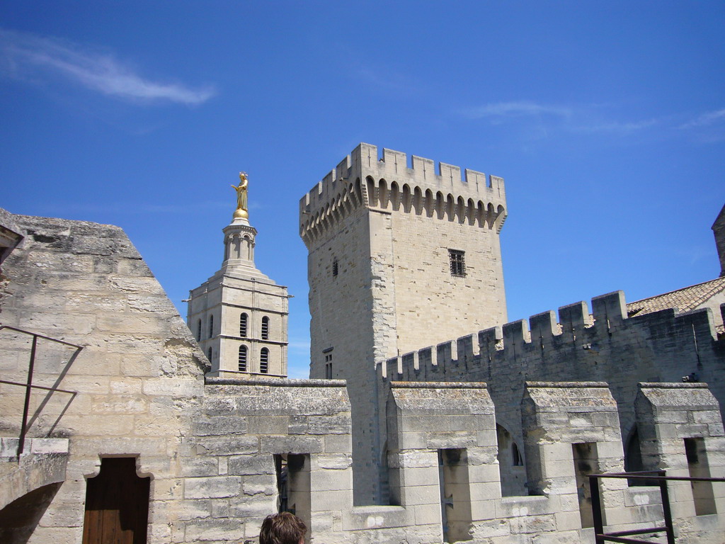 The Tour de la Campane tower of the Palais des Papes palace and the Gilded statue of the Virgin Mary at the top of the Avignon Cathedral, viewed from the roof of the Palais des Papes palace