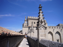 Roof and the Tour de la Campane tower of the Palais des Papes palace and the Gilded statue of the Virgin Mary at the top of the Avignon Cathedral, viewed from the roof of the Palais des Papes palace