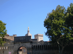 The Tour de la Campane tower of the Palais des Papes palace and the Gilded statue of the Virgin Mary at the top of the Avignon Cathedral, viewed from the Boulevard de la Ligne