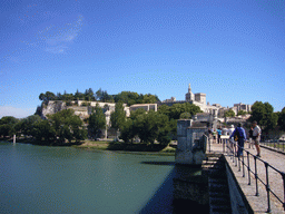 The Pont Saint-Bénezet bridge over the Rhône river, with a view on the Rocher des Doms gardens, the Avignon Cathedral and the Palais des Papes palace