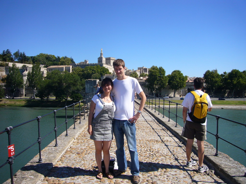 Tim and Miaomiao on the Pont Saint-Bénezet bridge over the Rhône river, with a view on the Rocher des Doms gardens, the Avignon Cathedral and the Palais des Papes palace
