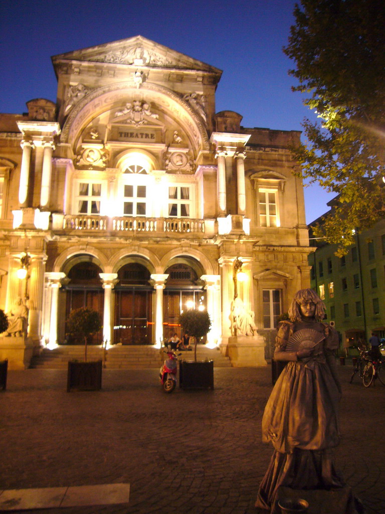 Living statue in front of the Opera Grand Avignon at the Place de l`Horloge square, by night