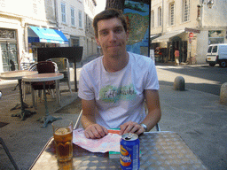 Tim with a drink on square in the city center