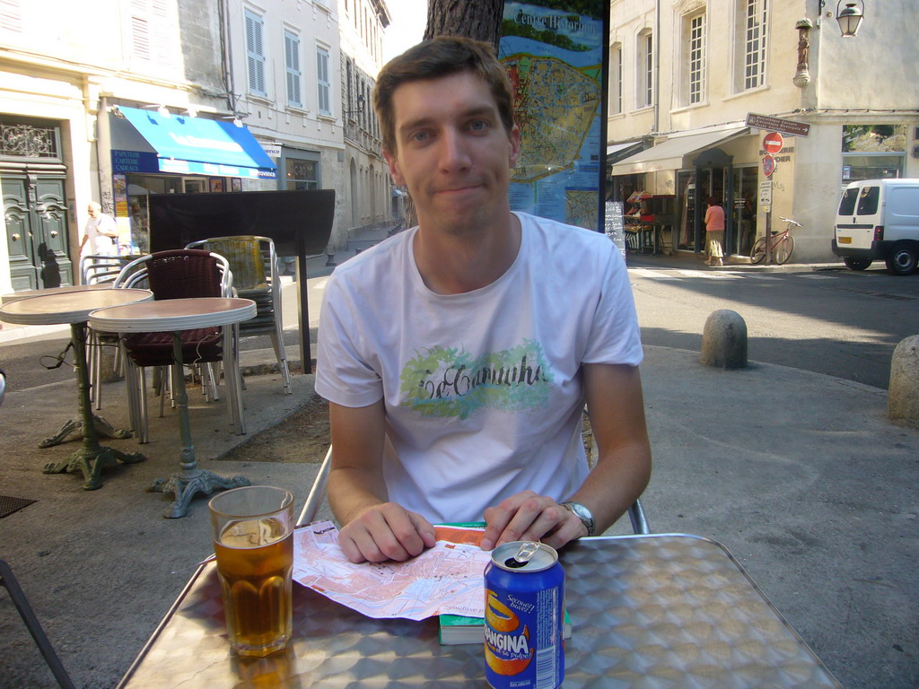 Tim with a drink on square in the city center