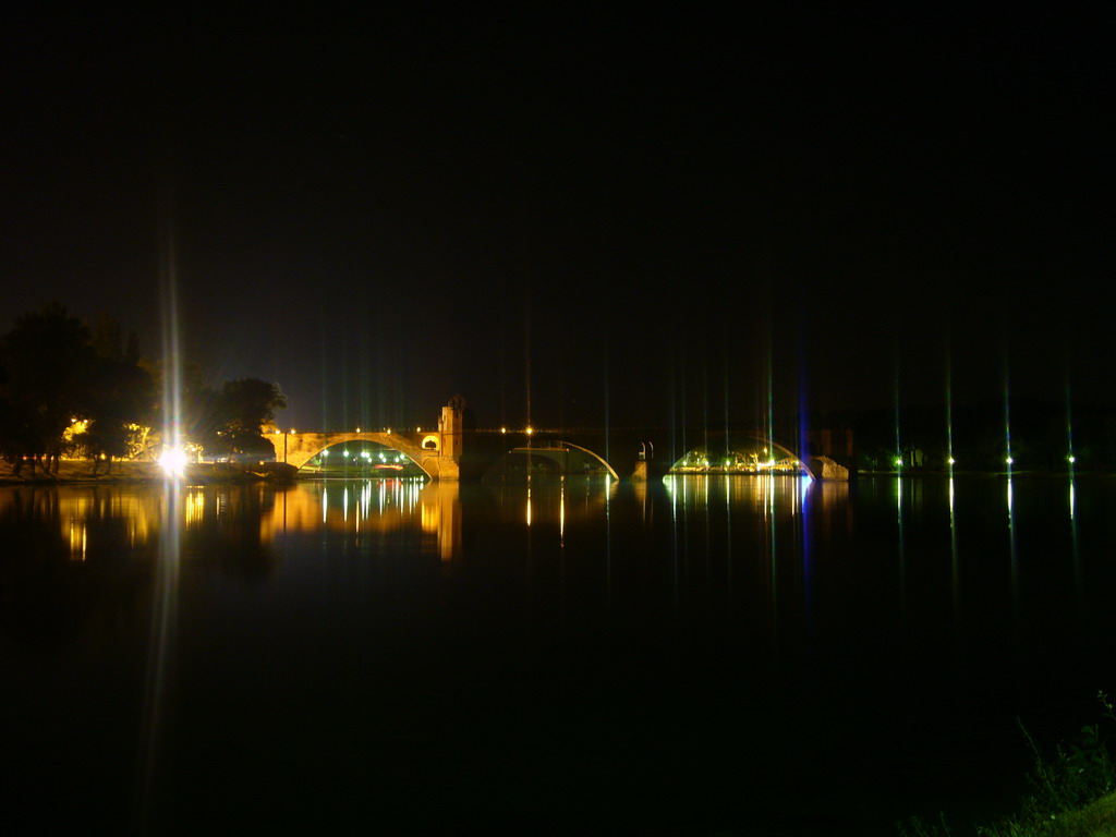 The Pont Saint-Bénezet bridge over the Rhône river, viewed from the Chemin de la Traille street, by night