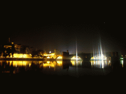 The Pont Saint-Bénezet bridge over the Rhône river, the Rocher des Doms gardens and the Gilded statue of the Virgin Mary at the top of the Avignon Cathedral, viewed from the Chemin de la Traille street, by night