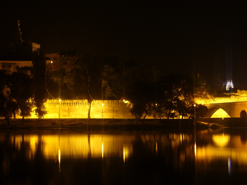 The Pont Saint-Bénezet bridge over the Rhône river, the Rocher des Doms gardens and the Gilded statue of the Virgin Mary at the top of the Avignon Cathedral, viewed from the Chemin de la Traille street, by night