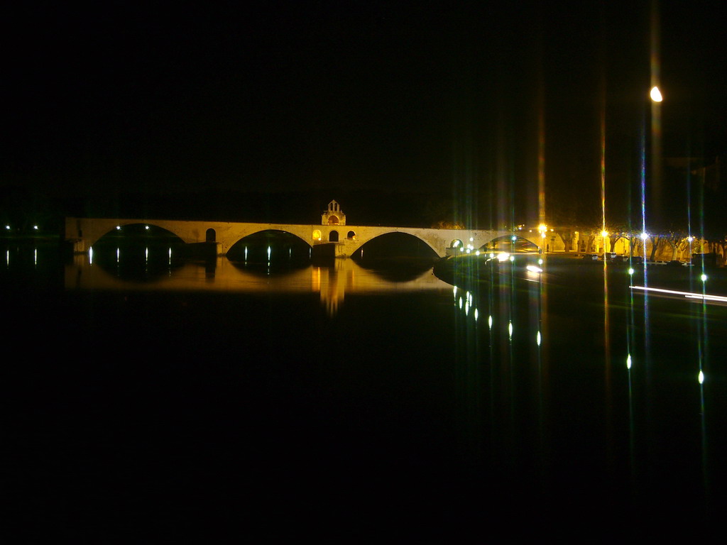 The Pont Saint-Bénezet bridge over the Rhône river, viewed from the Pont Édouard Daladier bridge, by night