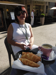 Miaomiao with coffee and croissants at the terrace of the Brasserie du Conservatoire at the Place Pie square