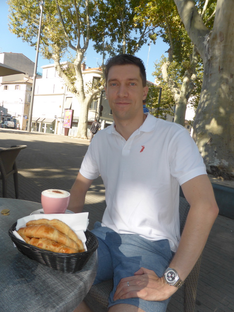 Tim with coffee and croissants at the terrace of the Brasserie du Conservatoire at the Place Pie square