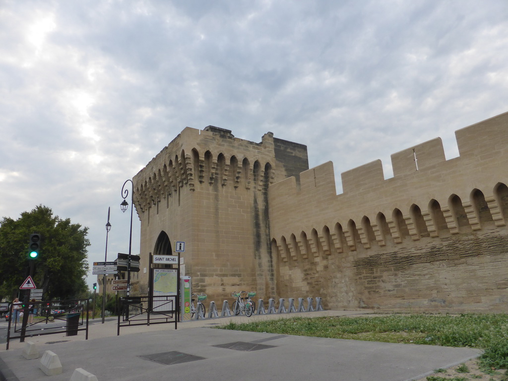 The Porte Saint-Michel gate through the City Wall of Avignon at the crossing of the Boulevard Saint-Michel and the Rue Saint-Michel street, viewed from our rental car