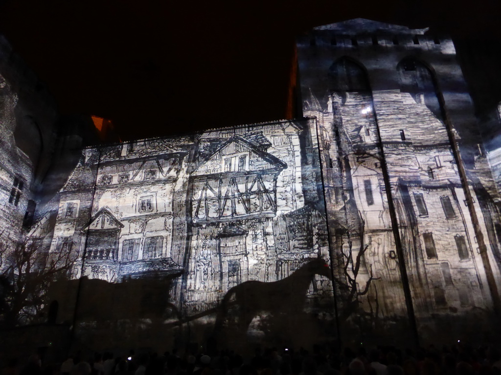 The eastern wall at the Cour d`Honneur courtyard of the Palais des Papes palace, during the Les Luminessences d`Avignon light show, by night