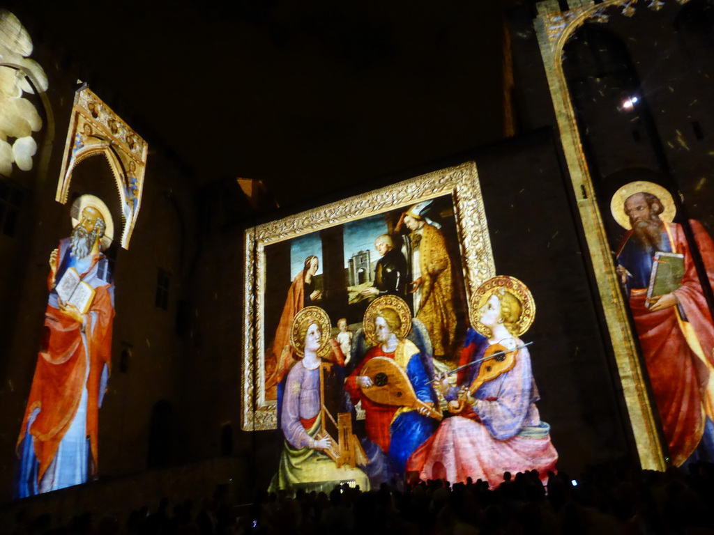 The northeastern wall at the Cour d`Honneur courtyard of the Palais des Papes palace, during the Les Luminessences d`Avignon light show, by night