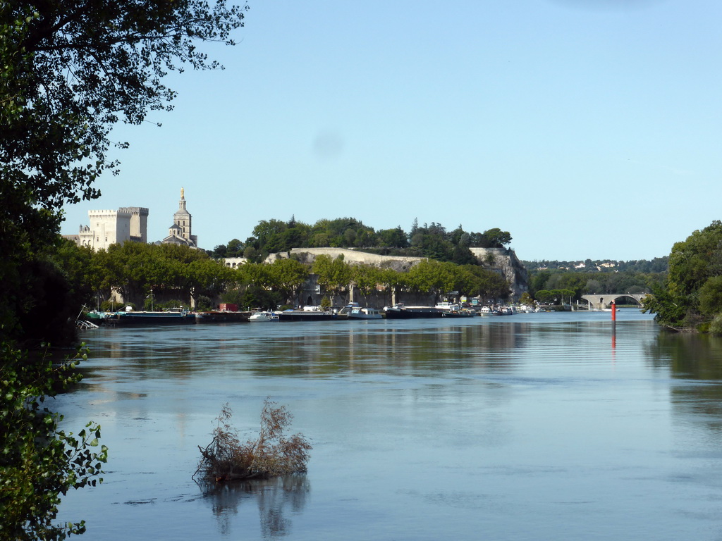 The Pont Saint-Bénézet bridge over the Rhône river, the northeast side of the Palais des Papes palace and the tower of the Avignon Cathedral, viewed from a parking place next to the Route Touristique du Dr. Pons road