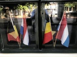 Dutch and Belgian flags in the window of the Tourist Office at the Singel street