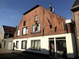 Front of a barber at the Klokkenstraat street, with Dutch and Belgian flags