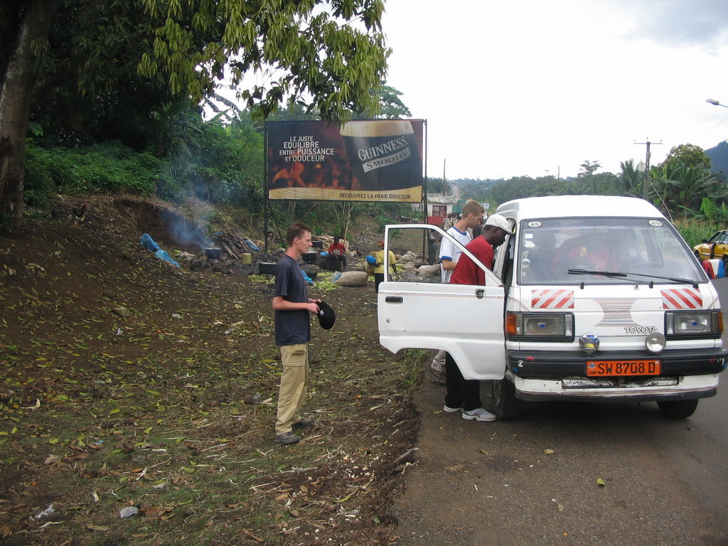 Tim`s friends next to the car along the road from Douala