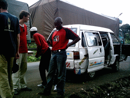 Tim and his friends next to the car along the road from Douala